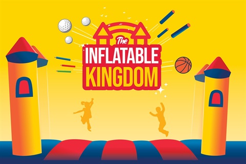 Children bouncing on giant inflatable castle.